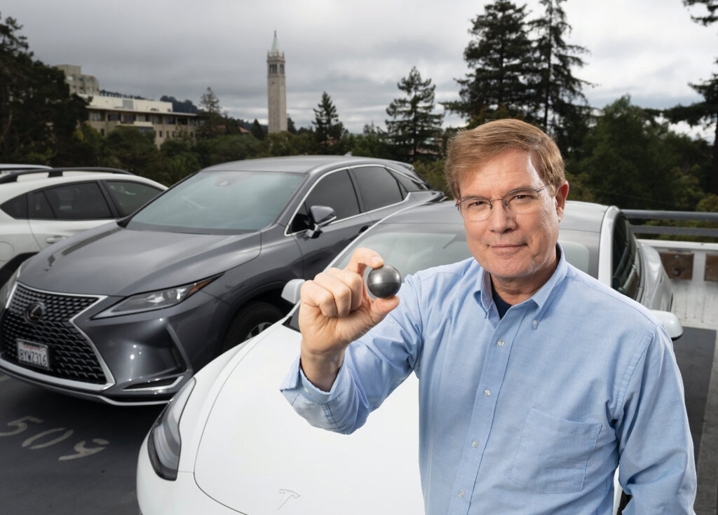 Professor Per Peterson holds a single fuel pebble, which can produce enough electricity to power a Tesla Model 3 for 44,000 miles.