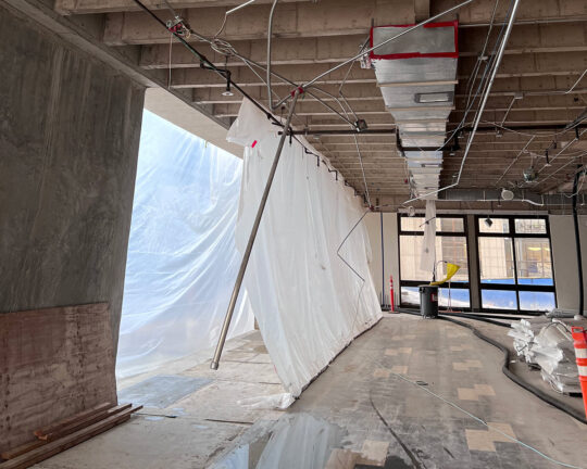 Hanging plastic sheeting and uncovered ceiling in Garbarini Lounge