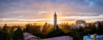 Wide-angle view of the UC Berkeley campus, with the sun setting behind the Campanile.