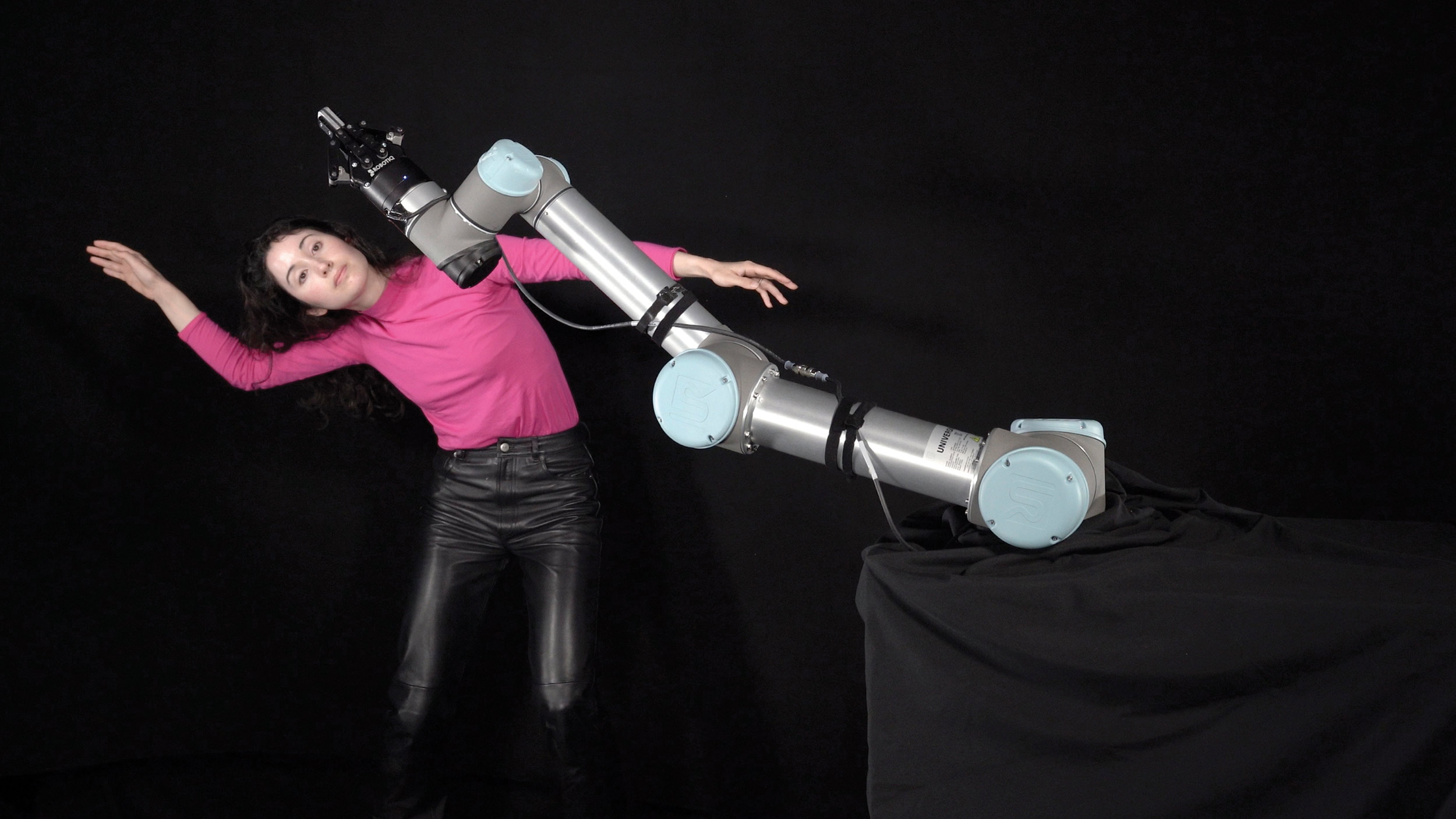 Dancer, roboticist and mechanical engineer Catie Cuan flails her arms, mimicking the movements of a UR5e robot arm, in the performance piece "Breathless."