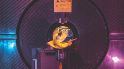 Professor Rebecca Abergel peers through a positron emission tomography (PET) scanner at Berkeley Lab