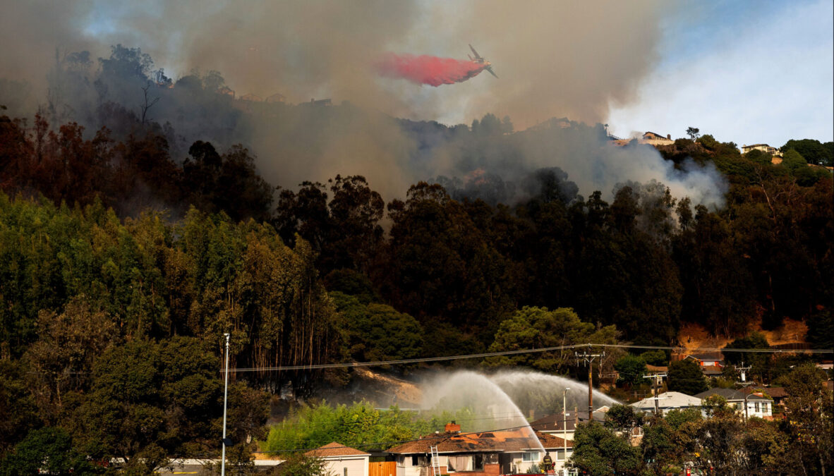 Firefighters work to contain a grass fire that broke out in the Oakland Hills on Oct. 18, 2024.