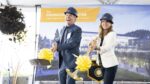 Photo of Michael and Janelle Grimes wearing hard hats and shoveling dirt at the Engineering Center groundbreaking ceremony.