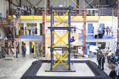 Wide shot of a three-story structure on top of the earthquake simulator at the UC Richmond Field Station.