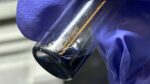 The purple/blue solution in this vial contains crystals of the berkelocene “sandwich.” (Credit: Alyssa Gaiser/Berkeley Lab)