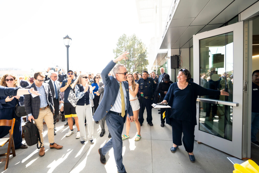 Alumnus and donor Michael Grimes waves attendees into the Grimes Engineering Center