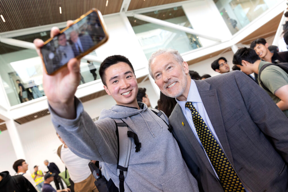 Chancellor Rich Lyons poses for a selfie with a student