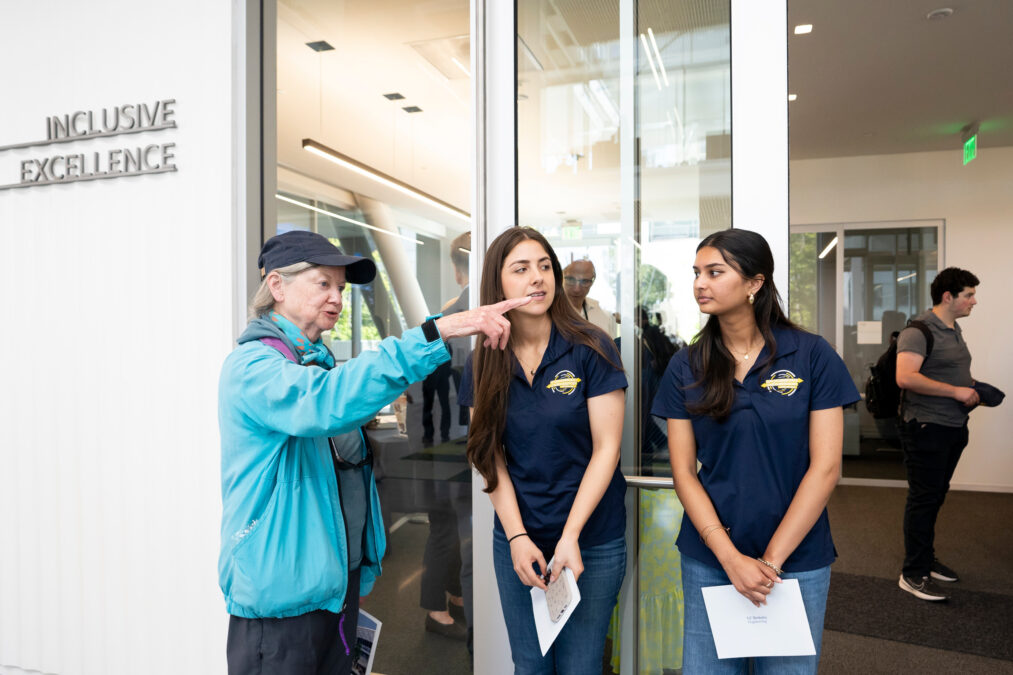 A visitor chats with students