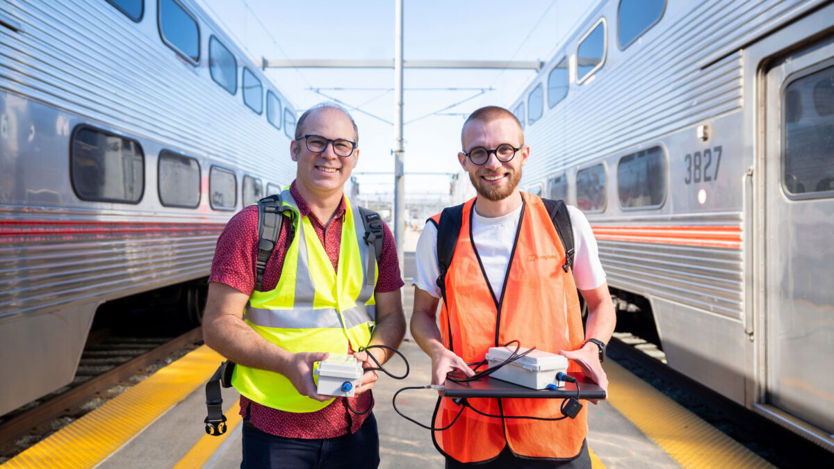 Civil and environmental engineering professor Joshua Apte and postdoc Sam Cliff take air quality measurements aboard diesel trains, which are in the process of being replaced by new electric trains at San Francisco Caltrain Station.