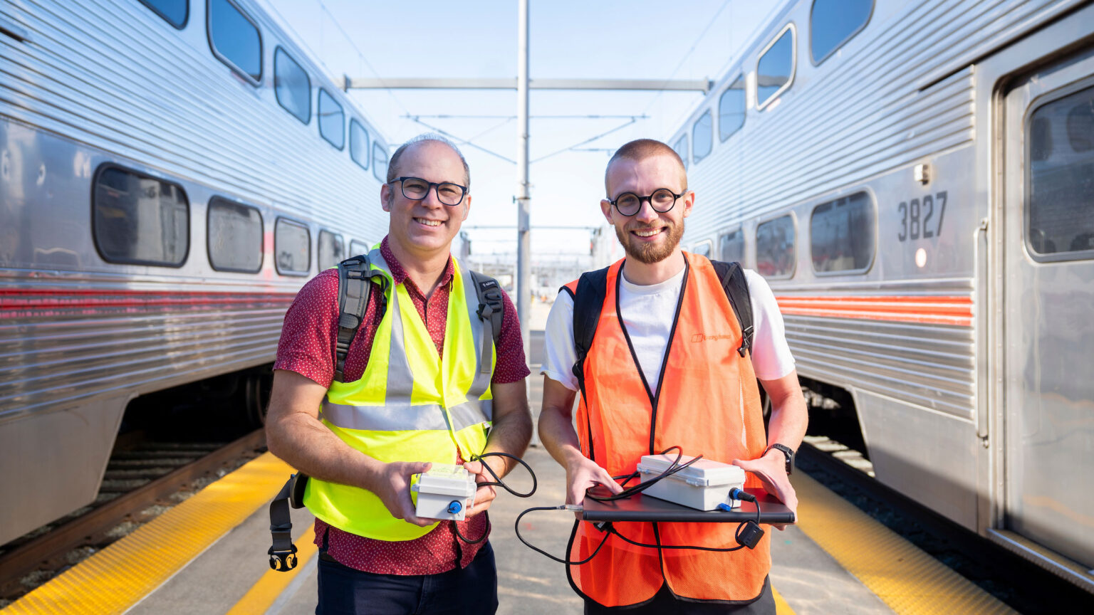 Civil and environmental engineering professor Joshua Apte and postdoc Sam Cliff take air quality measurements aboard diesel trains, which are in the process of being replaced by new electric trains at San Francisco Caltrain Station.