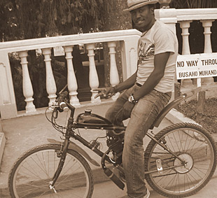 Ategeka on a bicycle in Uganda.